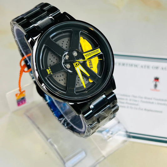 Black and yellow watch with metal band on a display stand