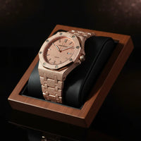Rose gold watch in a wooden box on a dark background