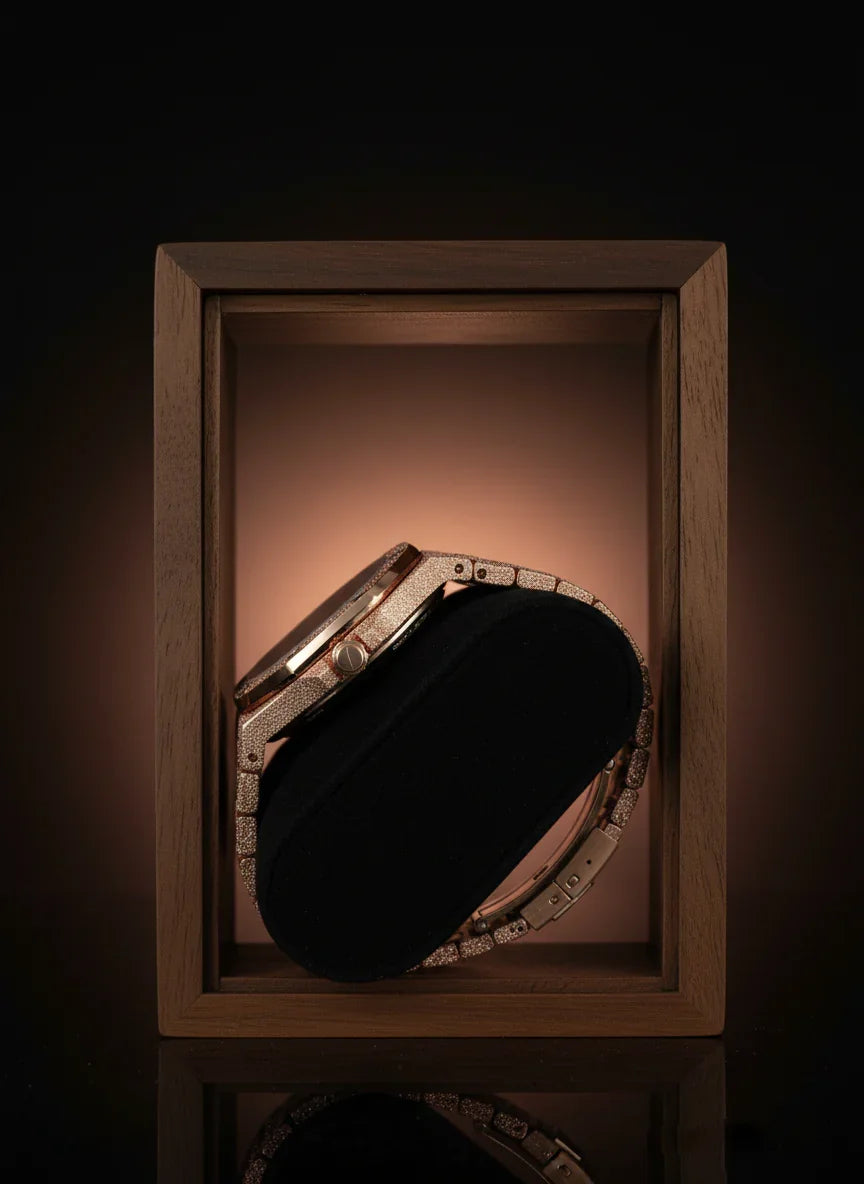 Decorative compact mirror with rhinestone embellishments in a wooden box on a dark background