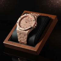 Rose gold watch with diamond accents on a wooden display box against a dark background