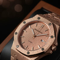 Luxury watch with rose gold case and bracelet on a dark background