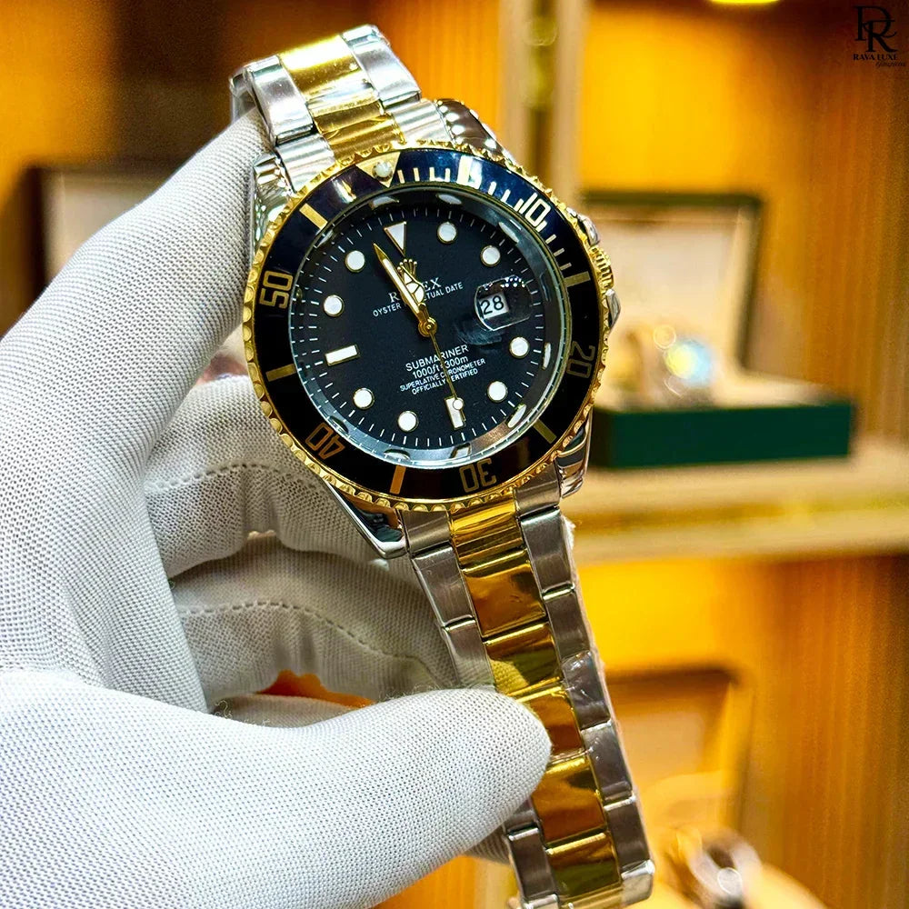 Gold and silver watch with black dial held by a gloved hand against a blurred background