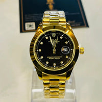 Gold watch with black dial on a stand, with a blurred background