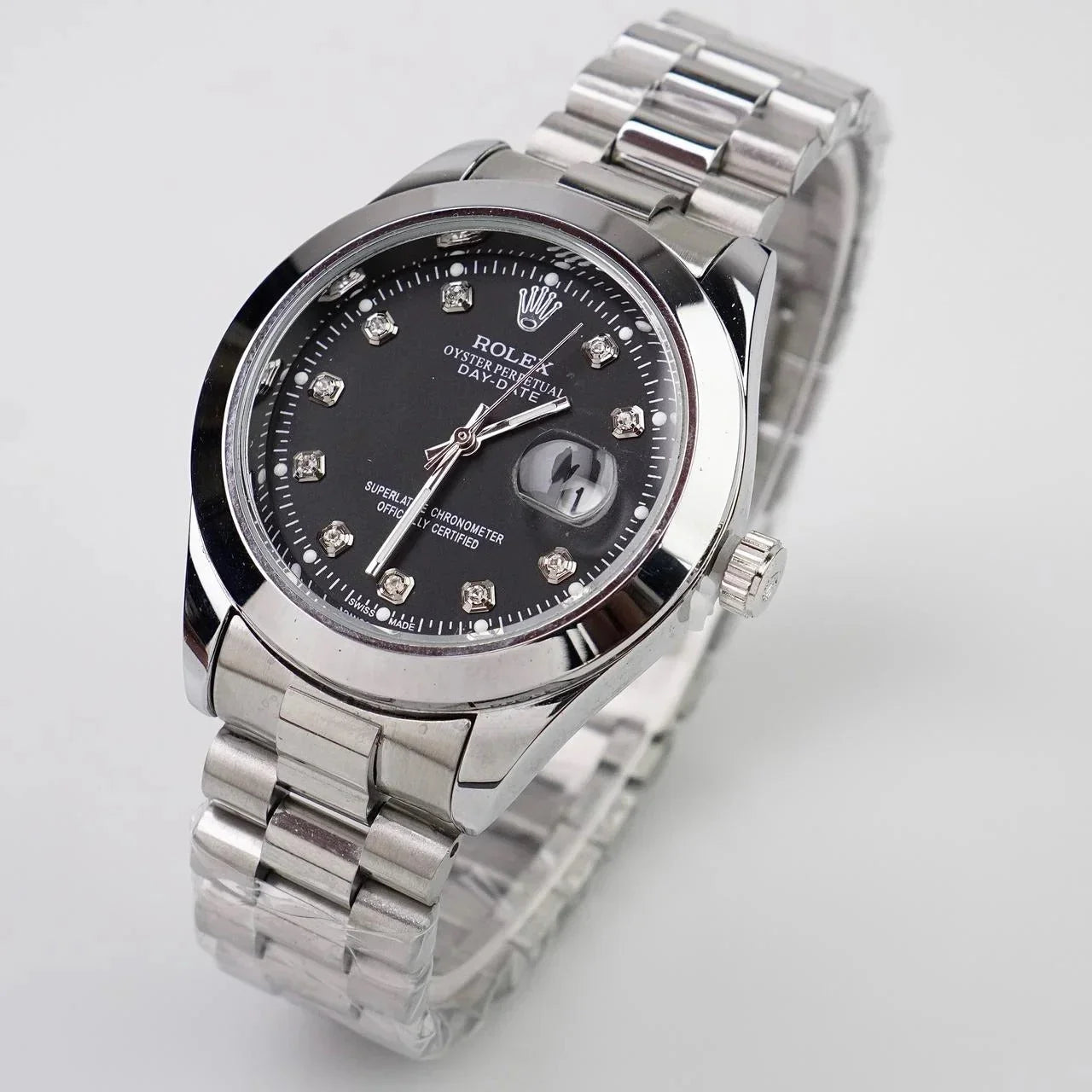 Silver watch with black dial featuring diamond accents on a light gray background