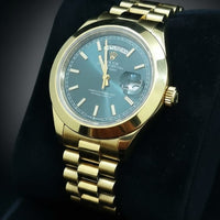Gold wristwatch with a blue face on a black background