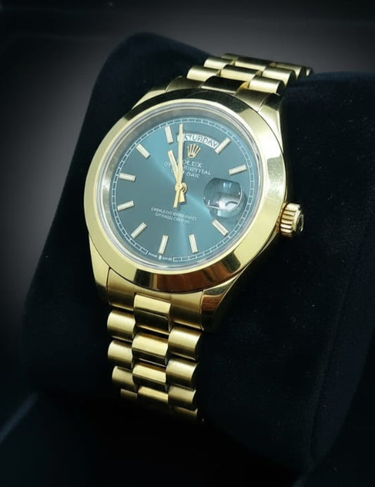 Gold wristwatch with a blue face on a black background