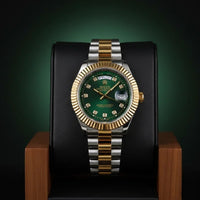 Luxury watch with green dial and gold and silver band on a dark background