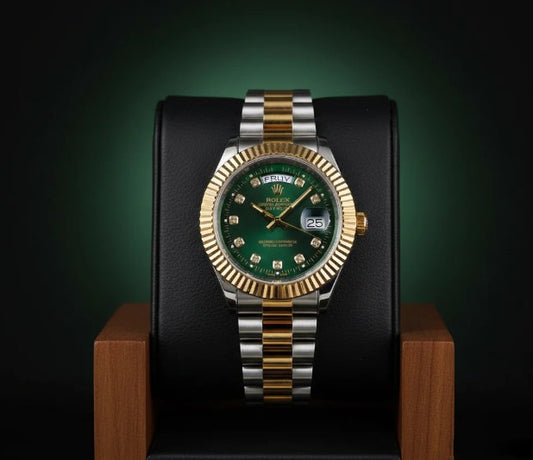 Luxury watch with green dial and gold and silver band on a dark background